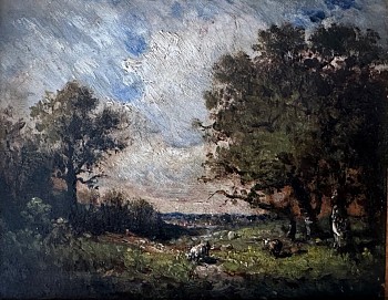 Richly painted trees border the edges of a rocky pasture.