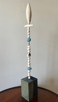 Porcelain forms are stacked on top of each other to create a table top totem.